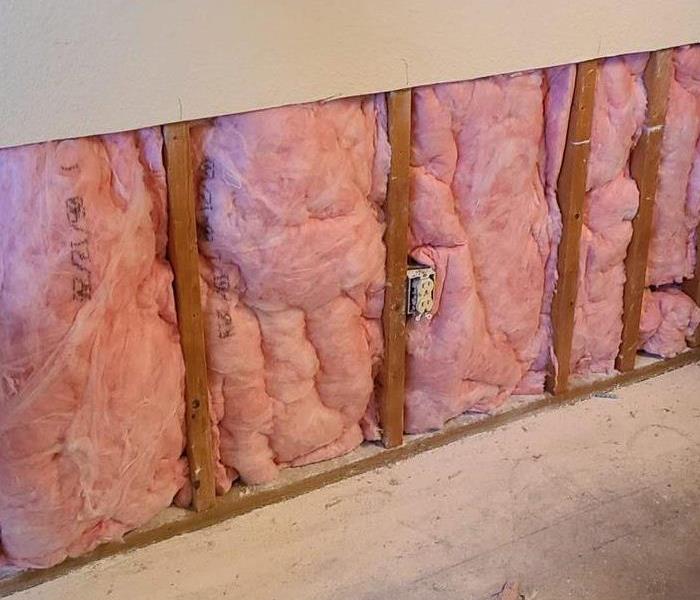 pink insulation in flood cut of drywall