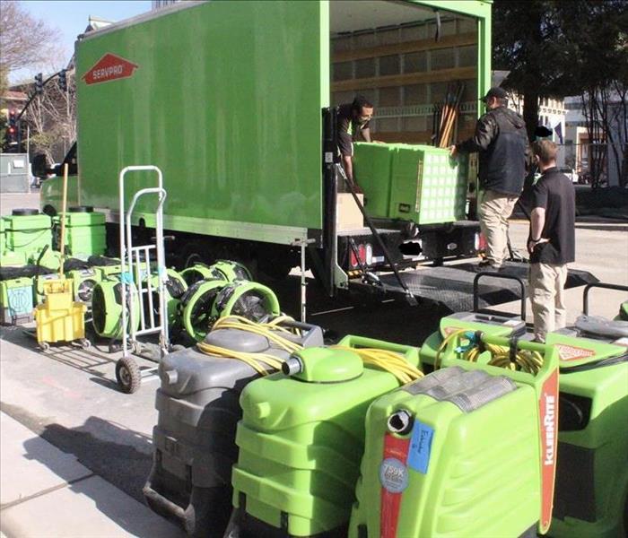 Green vehicle with green equipment. water extraction equipment for water damage in old sacramento