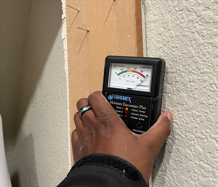 moisture meter next to wall