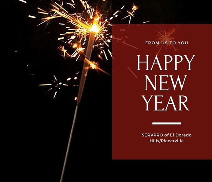 sparkler on black background with text in red box saying from us to you happy new year servpro of el dorado hills/placerville